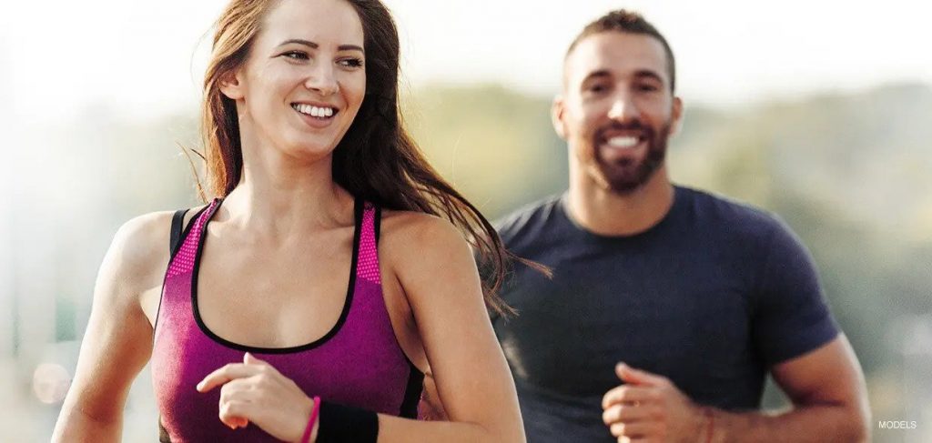 Young Couple in Athletic Clothes Running