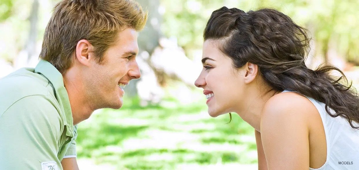 Happy Young Couple Smiling In Park