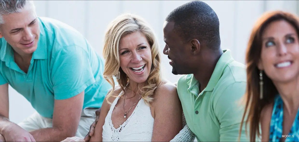 Beautiful Woman and Handsome man Sharing a Smile while Sitting Down