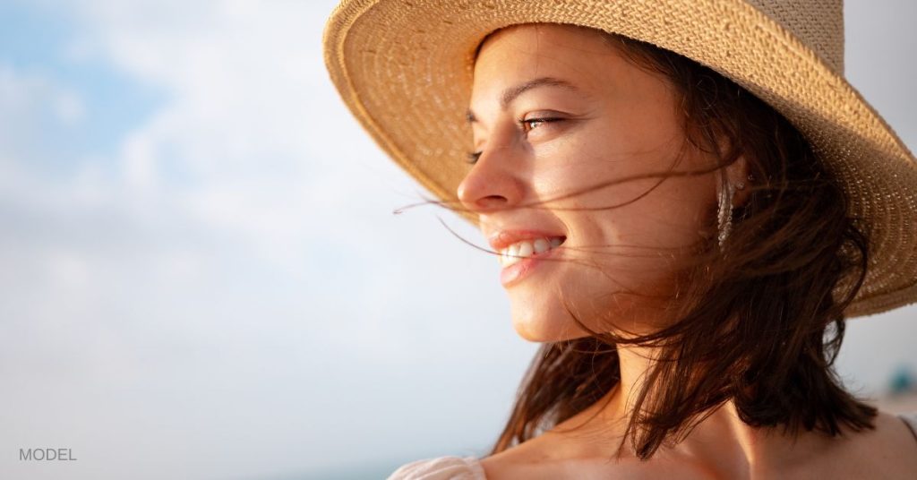 Beautiful woman smiling and looking to the side. (MODEL)