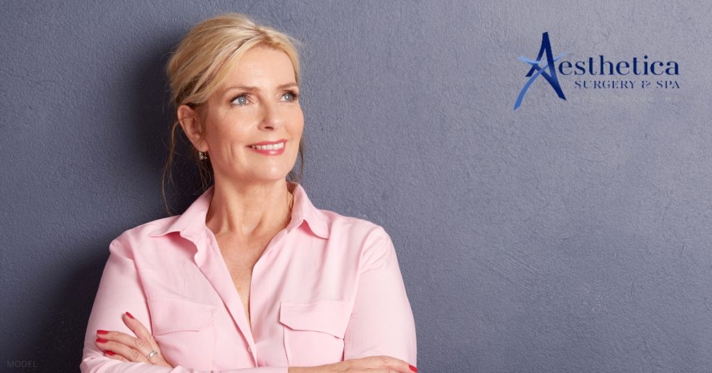 Smiling woman representing facelift results (model) Aesthetica Surgery & Spa Logo